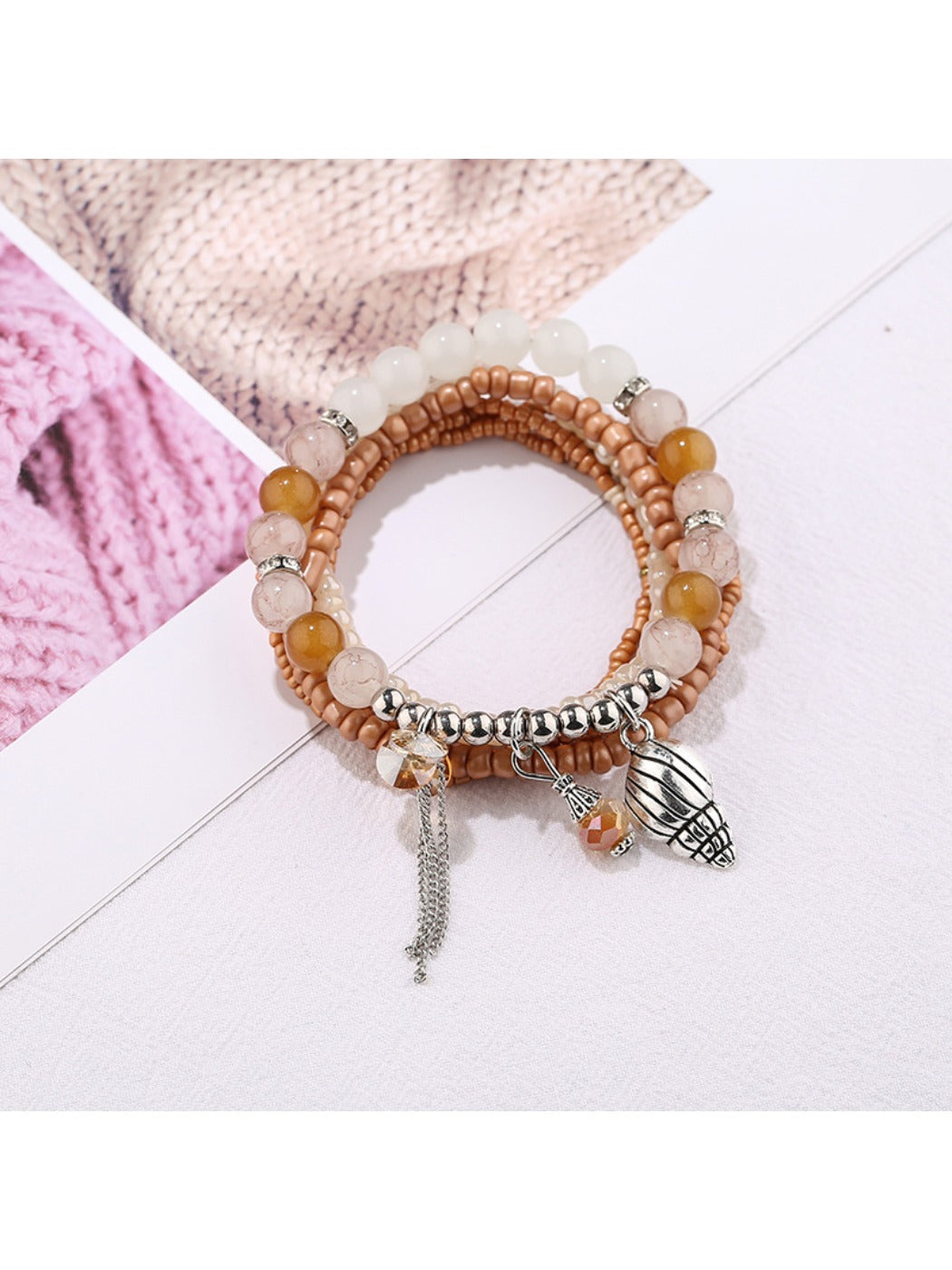 Side view of Lovra alloy pendant bracelet with alternating silver beads and charm