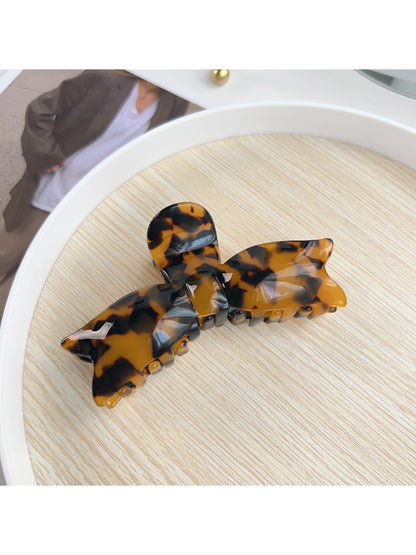 Beau bow shaped hair claw clip with spring mechanism visible