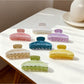 Beau minimalist candy color claw clip in pastel pink on white background