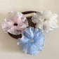 Side view of Gifty solid color scrunchie highlighting ruffled design