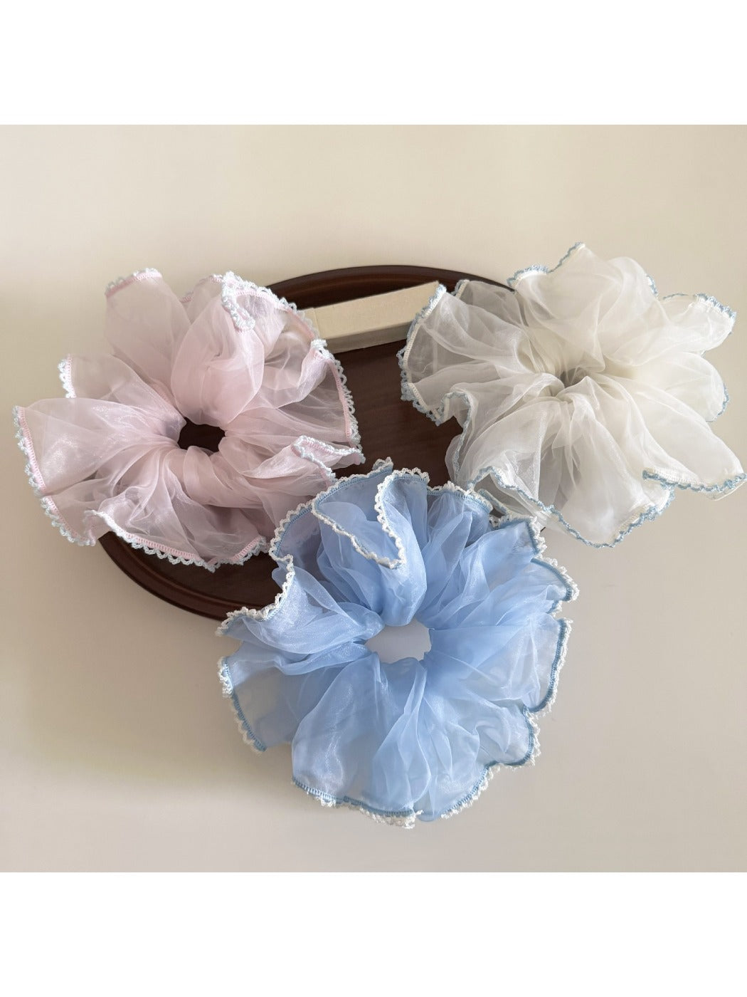 Side view of Gifty solid color scrunchie highlighting ruffled design