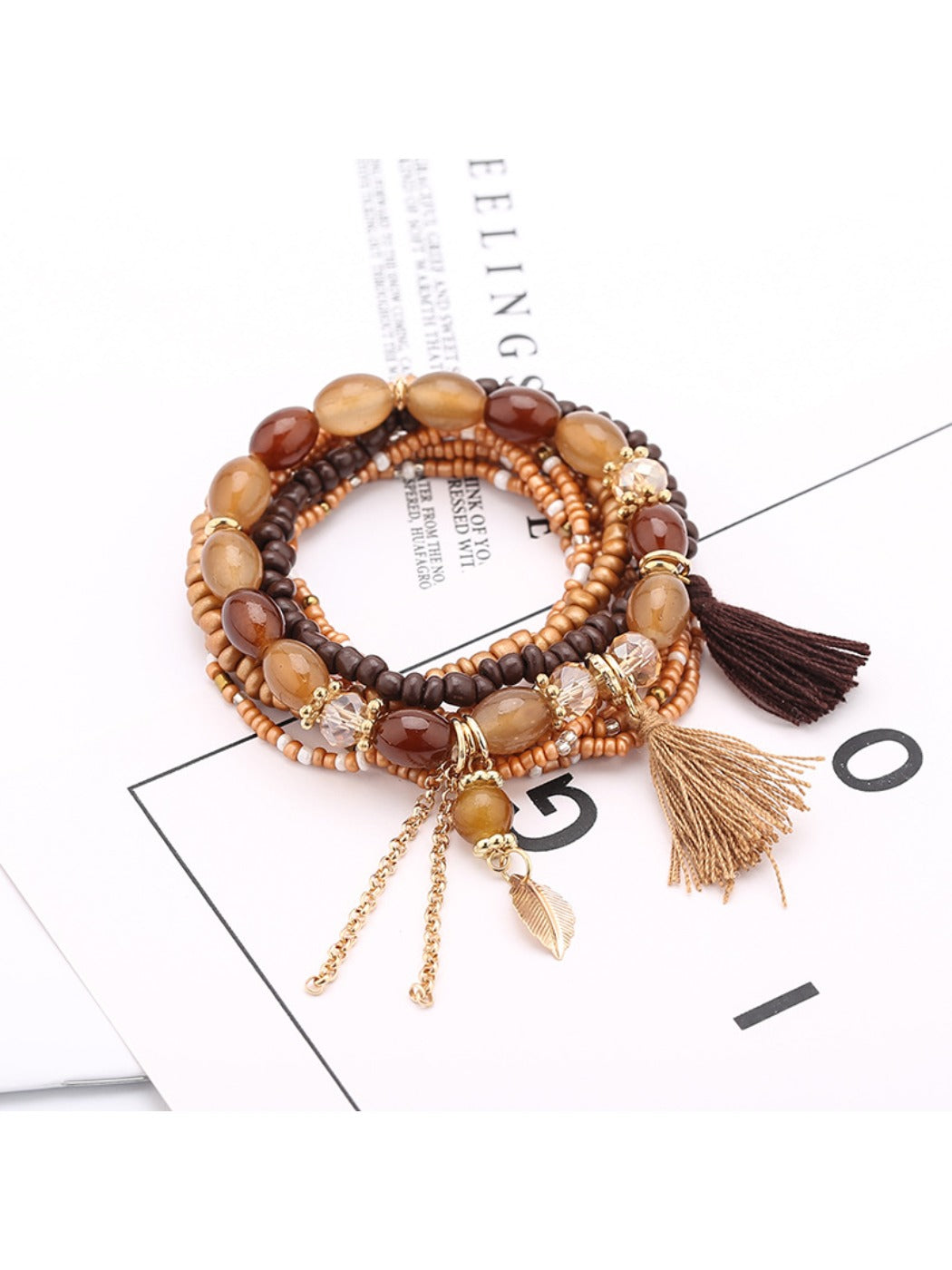 Lovra tassel pendant beaded bracelet styled with casual outfit on model's wrist