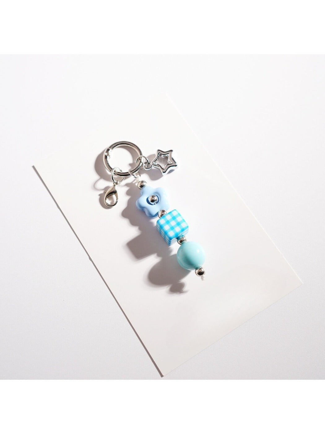 Close-up of the silver keyring attached to the colorful beaded star keychain