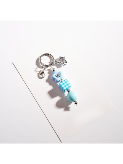 Close-up of the silver keyring attached to the colorful beaded star keychain