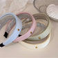 Fresh colorful fabric headband with gentle pastel stripes on white background