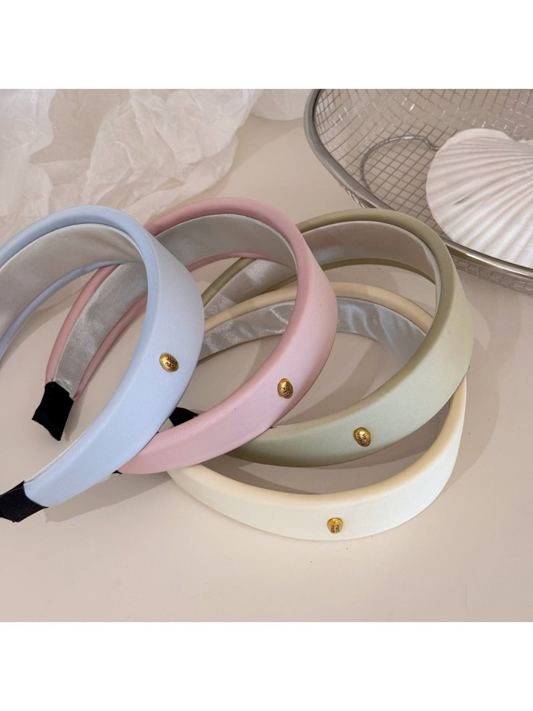 Fresh colorful fabric headband with gentle pastel stripes on white background