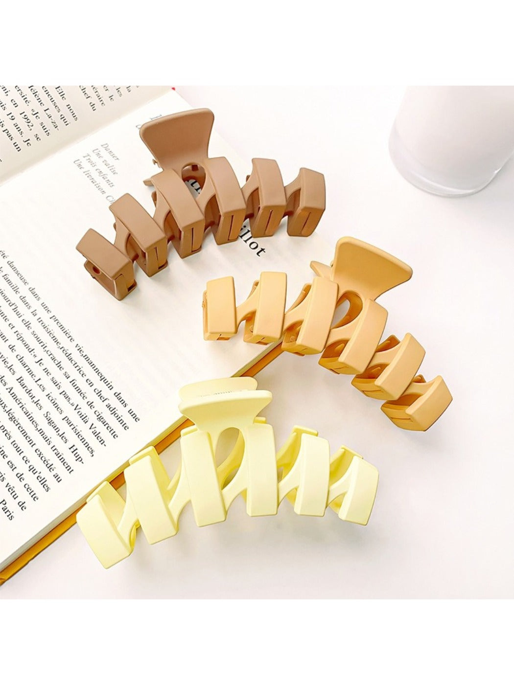 Beau hair claw clip held in hand highlighting size and wavy shape