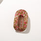 Beau hair clip held in hand illustrating compact size and lightweight design