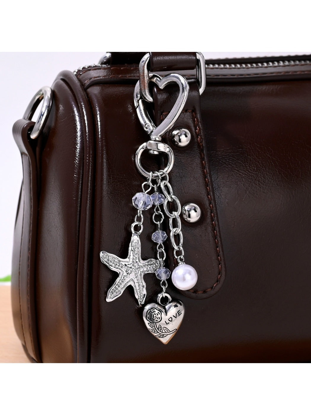 Starfish heart keychain attached to a set of keys on wooden surface