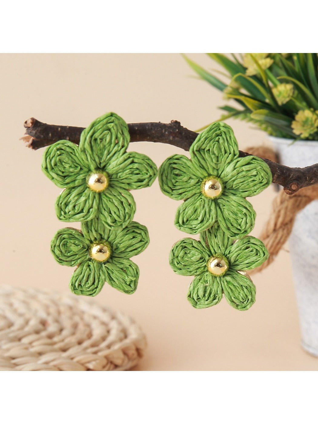 Model showcasing earedge raffia flower drop earrings with short hair