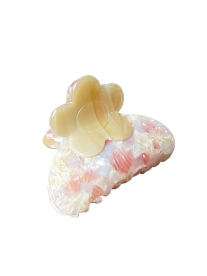 Beau hair clip displayed on a wooden surface highlighting flower details