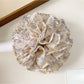 Side view of Gifty vintage multi layer tiny floral scrunchie showing fabric layers and floral pattern