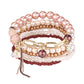 Lovra stackable bracelet with tassel charm paired with other bracelets on wrist