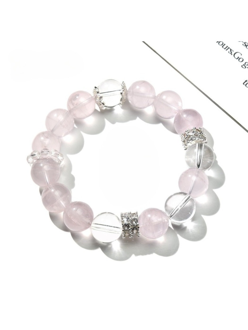 Close-up of Lovra pink and white crystal beaded bracelet on a white background