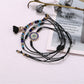 Lovra small bead tassel alloy bracelet worn on wrist with natural lighting