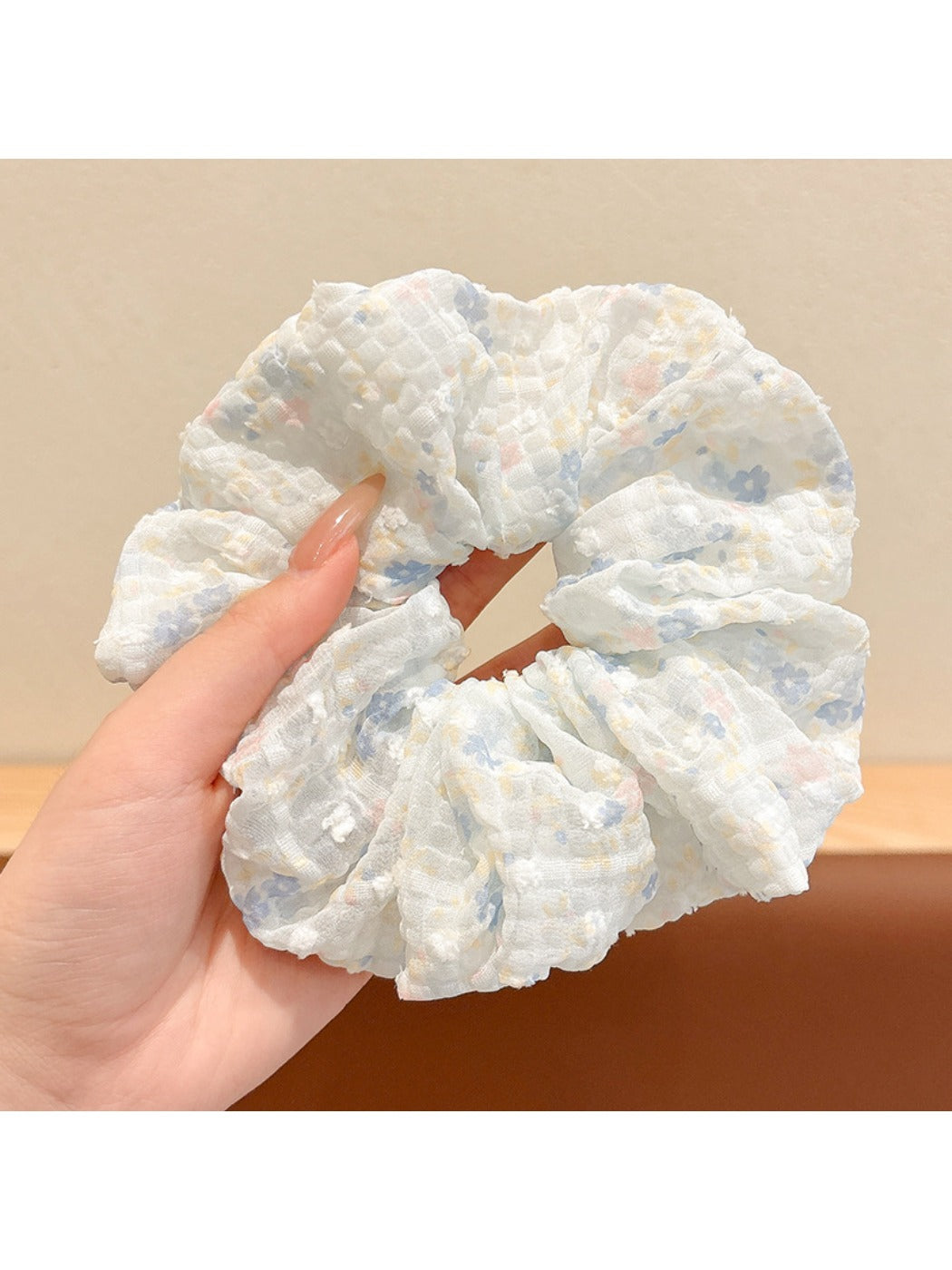 Gifty scrunchie styled with casual outfit on a model's wrist
