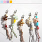 Close-up of Keypus acrylic beaded flower keychain with pink and white beads