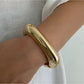 Lovra wide round bangle bracelet displayed on a hand model to show size and fit