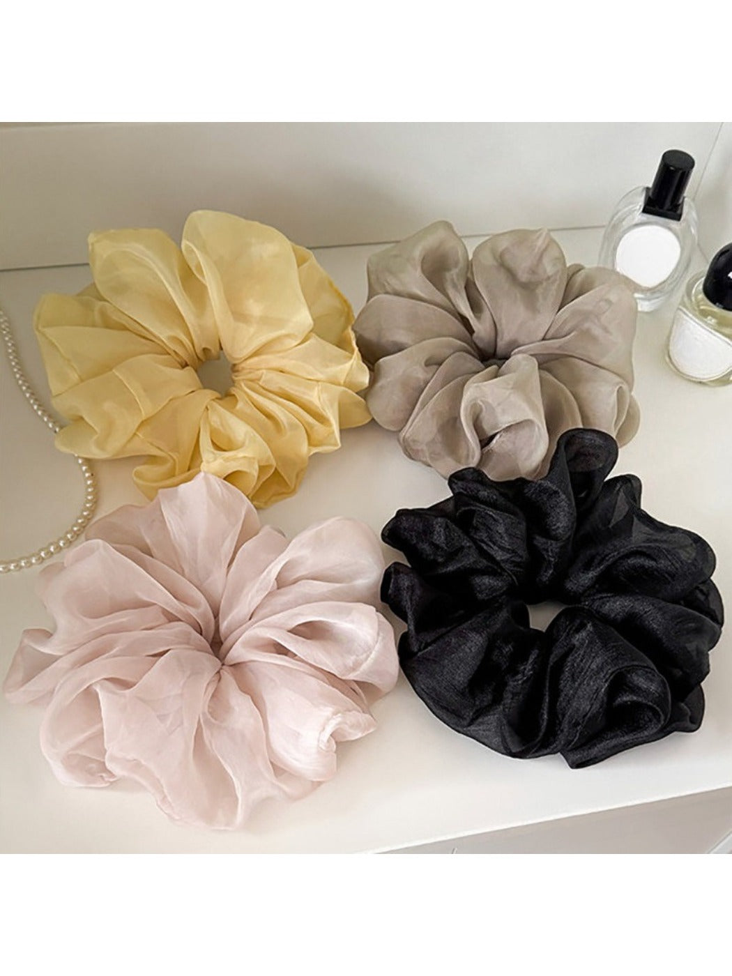 Close-up of a solid color ruched scrunchie with gathered fabric detail