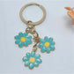 Peach blossom keychain displayed on a white background with soft shadows