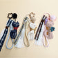 Fabric cat keychain attached to a set of keys on a wooden surface