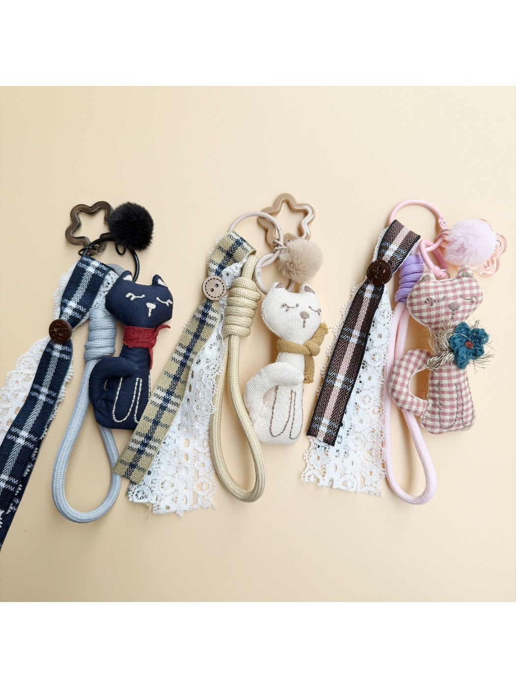 Fabric cat keychain attached to a set of keys on a wooden surface