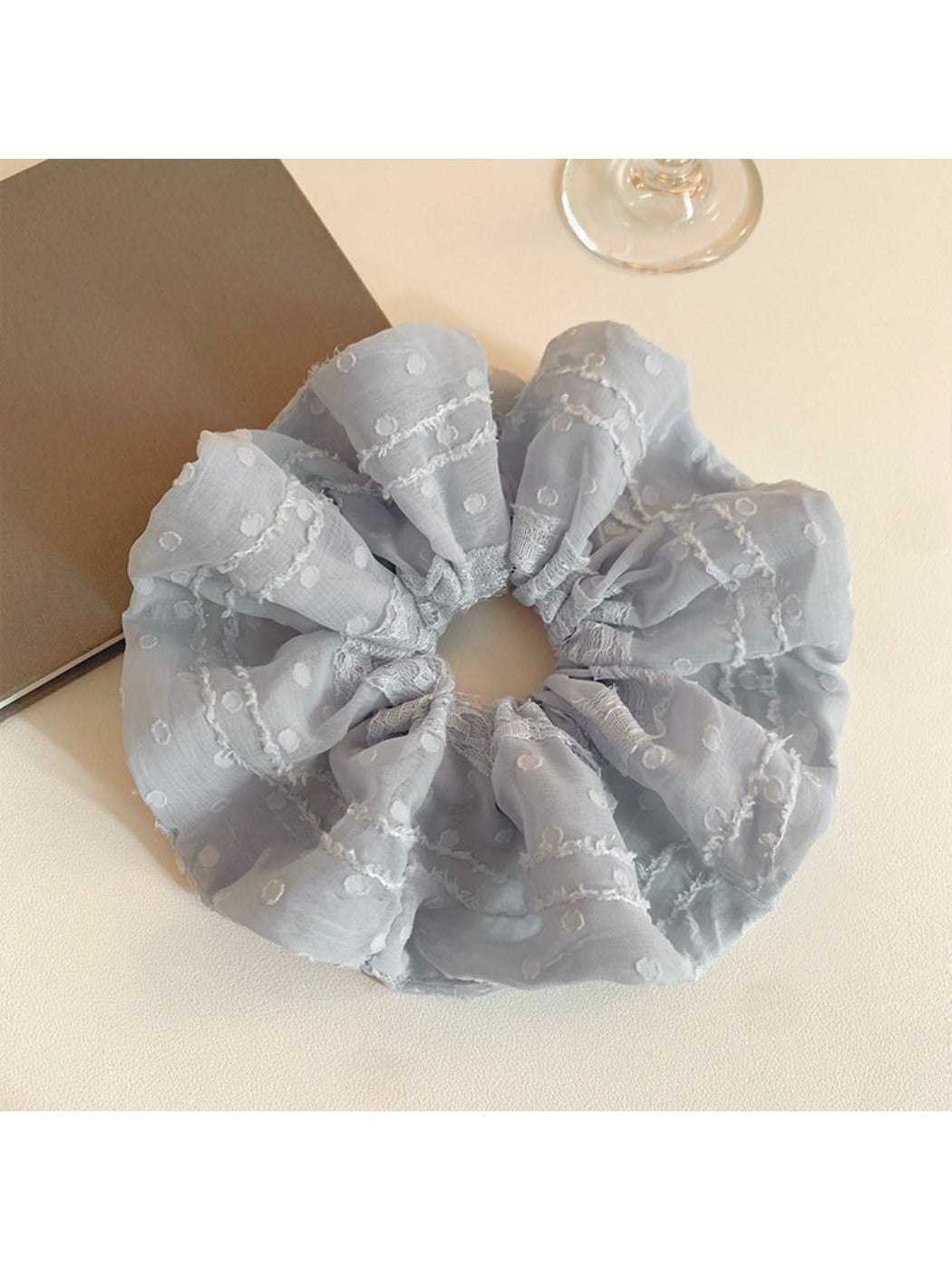 Multiple Gifty ruffled scrunchies in different solid colors displayed together