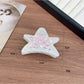 Beau shark claw clip placed on wooden surface with natural lighting