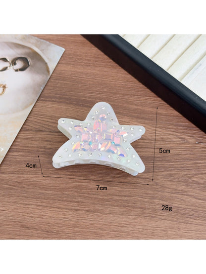 Beau shark claw clip placed on wooden surface with natural lighting