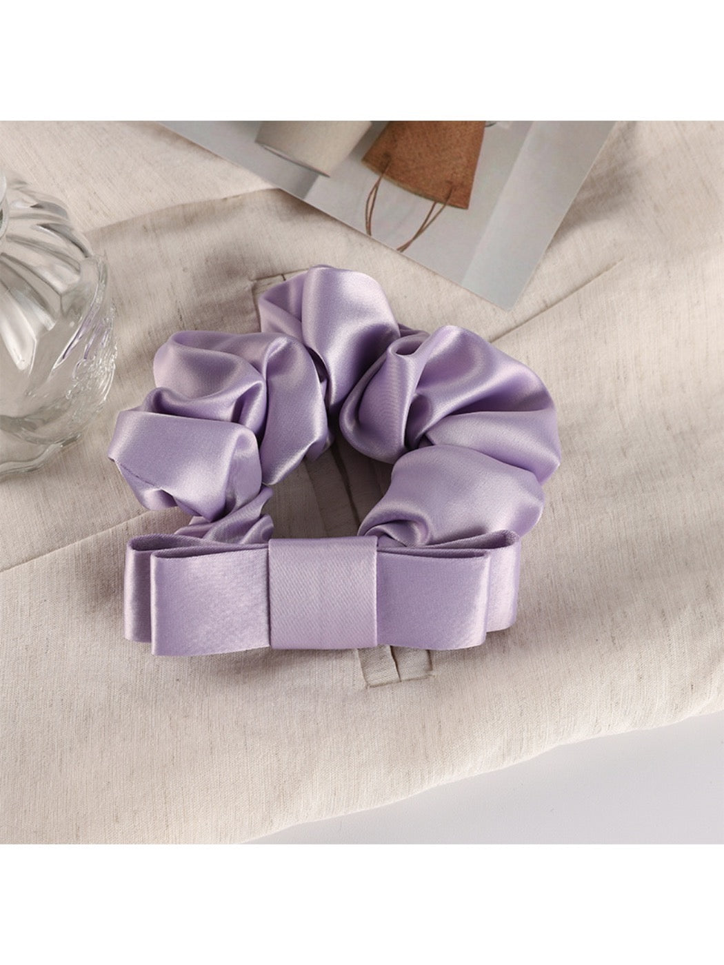 Scrunchie wrapped around a wrist as a stylish accessory in soft pink tones