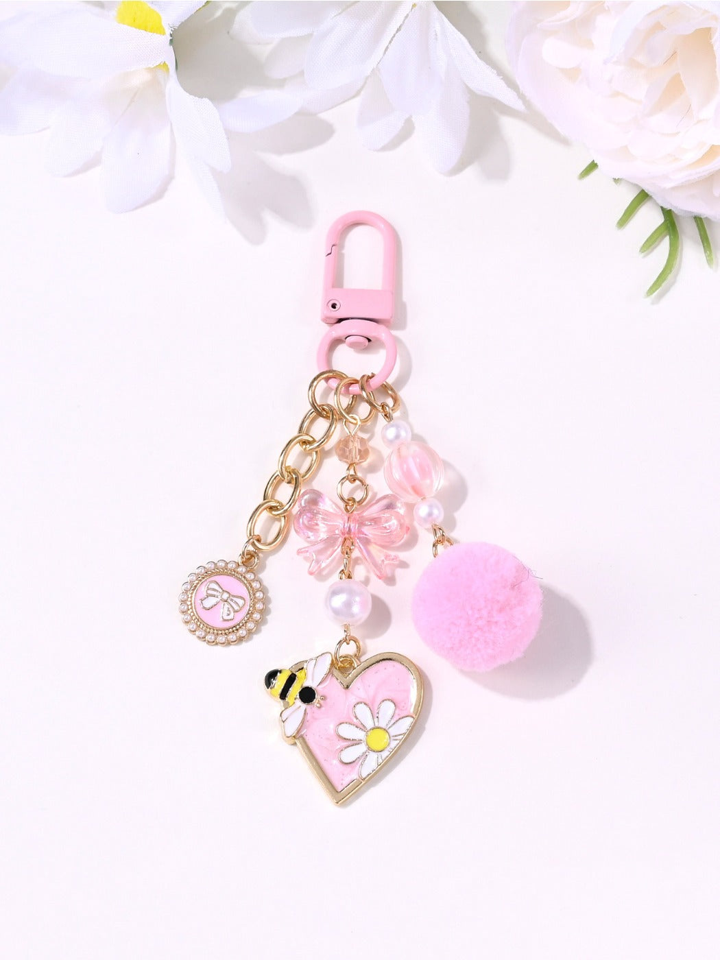 Side view of the pink heart-shaped keychain highlighting its thickness