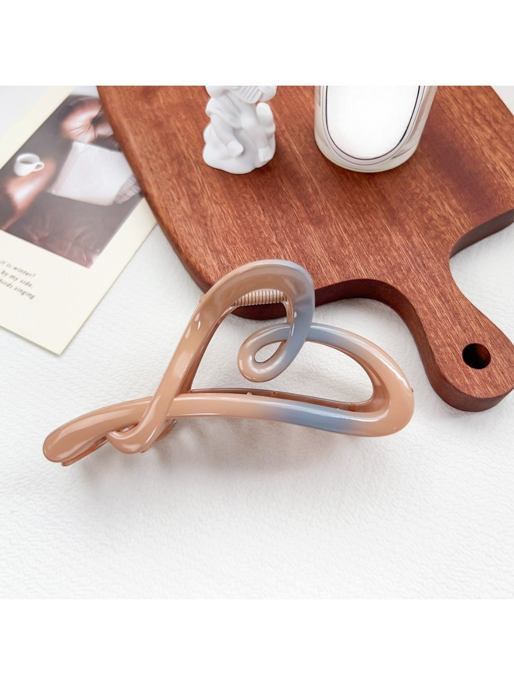 Beau ombre heart shaped bow claw clip shown in natural light highlighting color transition