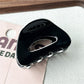 Beau minimalist claw clip angled to show smooth matte finish
