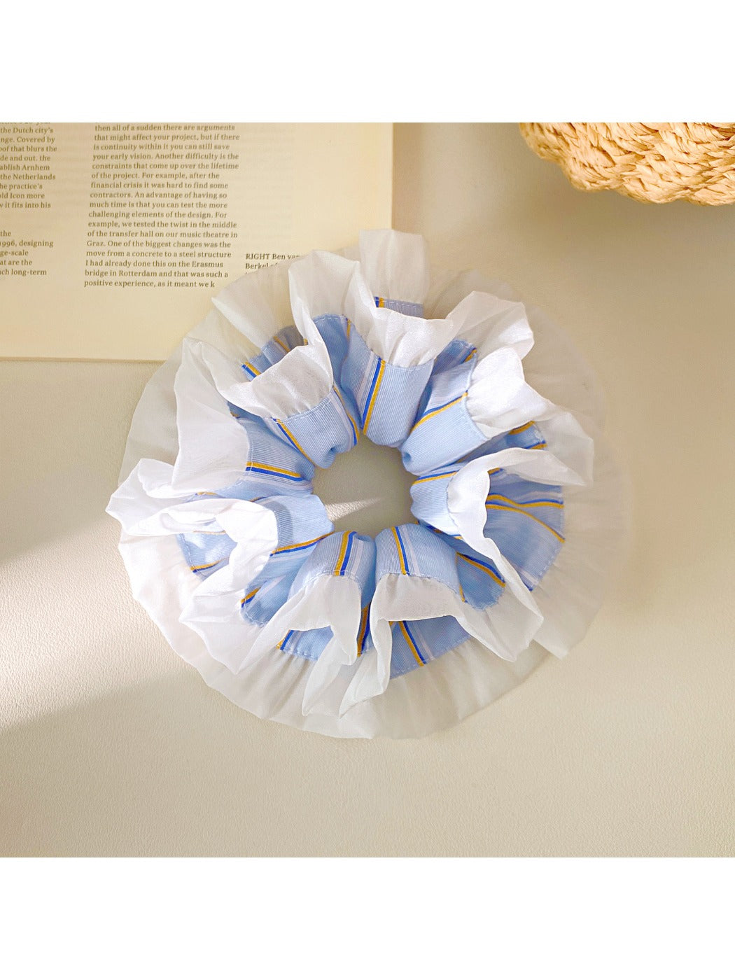Blue stripe ruffle scrunchie wrapped around a ponytail