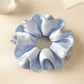 Blue satin double layer scrunchie with smooth and shiny fabric texture