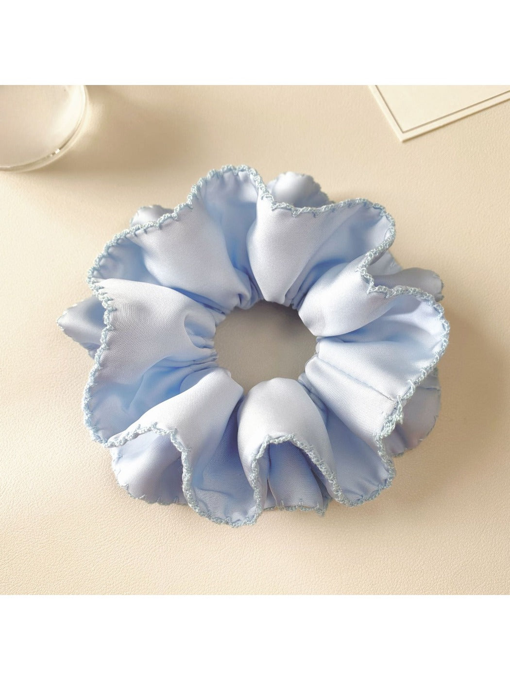 Blue satin double layer scrunchie with smooth and shiny fabric texture