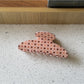 Beau polka dot claw clip displayed with matching hair accessories