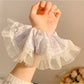 Side view of Gifty floral scrunchie highlighting delicate lace trim and fabric texture