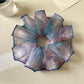 Multiple Gifty floral scrunchies stacked together showing color variations