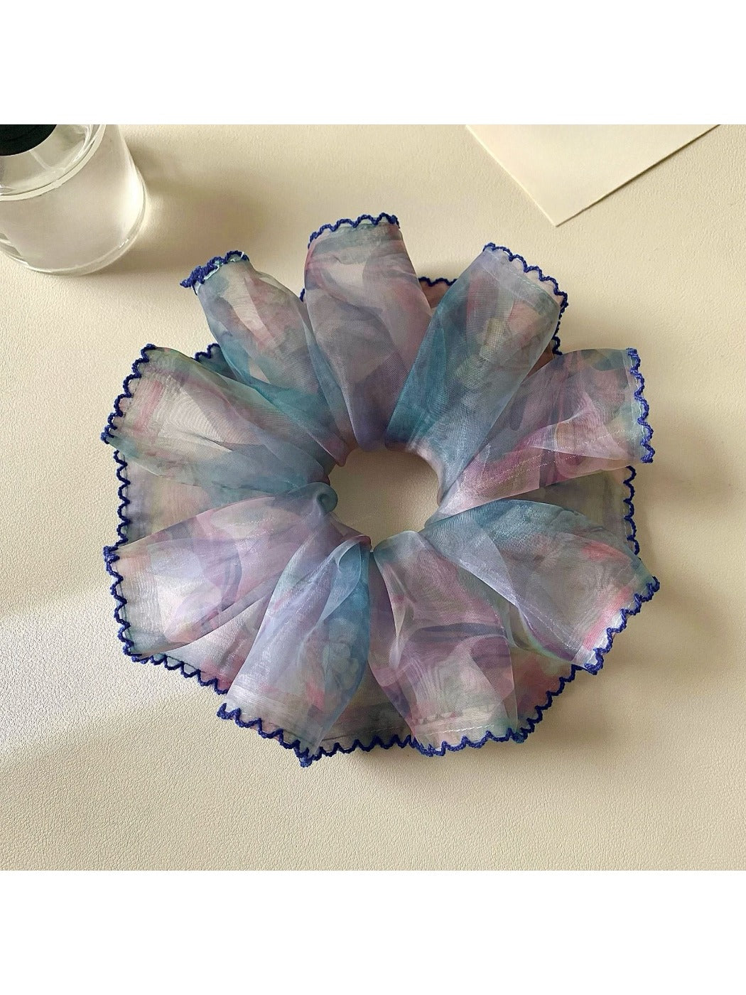 Multiple Gifty floral scrunchies stacked together showing color variations