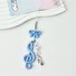 Keypus music note keychain lying flat with a soft shadow on a white surface