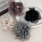 Classic solid color ruffled scrunchie in soft fabric, styled on a white background