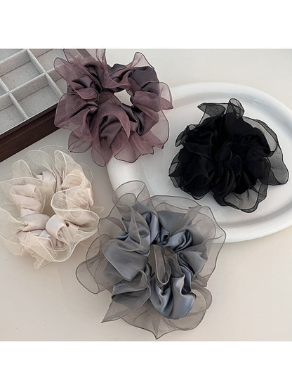 Classic solid color ruffled scrunchie in soft fabric, styled on a white background