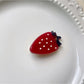 Beau chocolate hair clip held in hand showing size and shape
