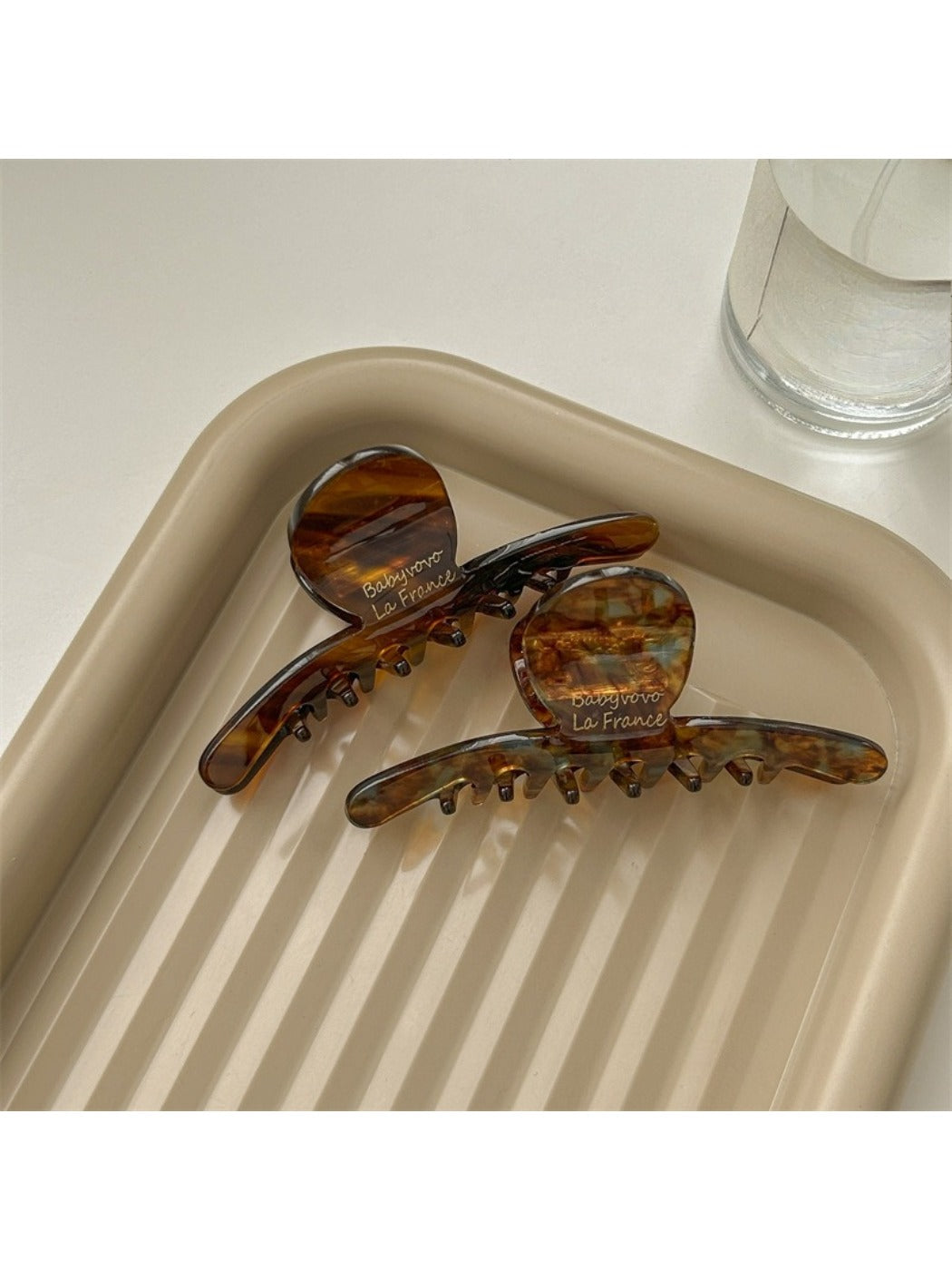 Beau acetate brown style claw clip on white background showing curved design
