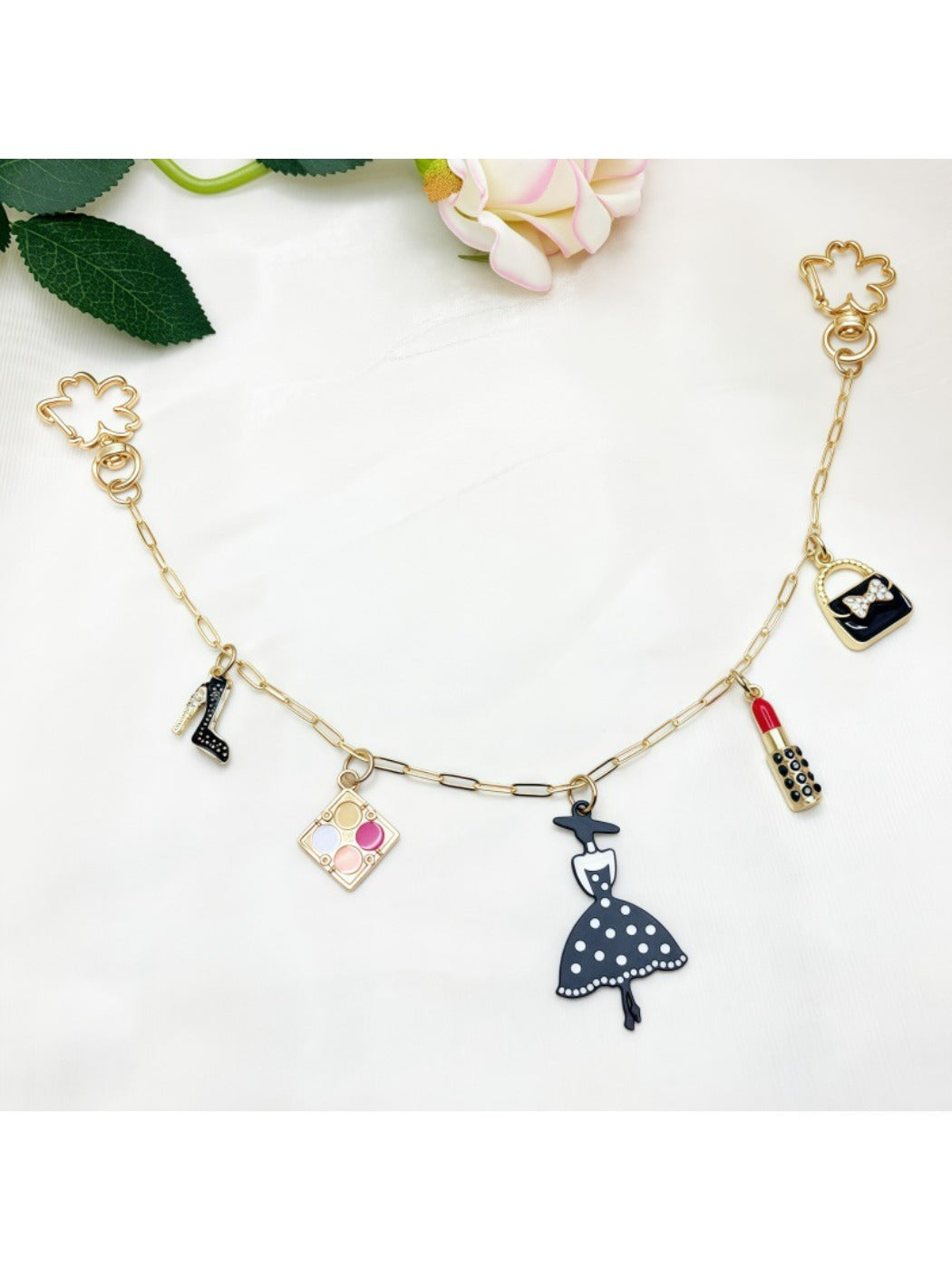 Keypus pendant bag charm attached to a leather handbag strap