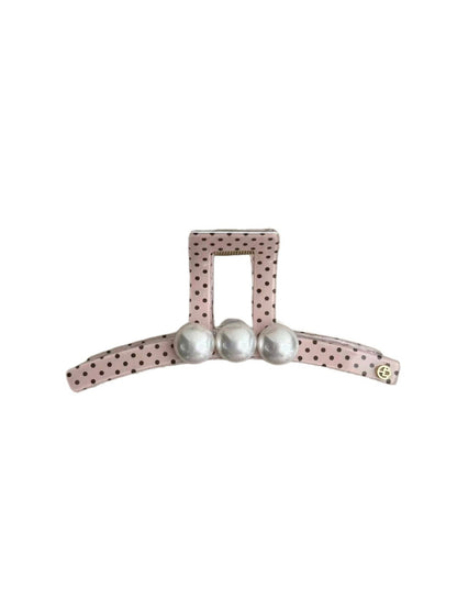 Close-up of Beau polka dot pink hair clip showing metal clasp and design details