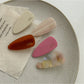 Beau pink tone hair clip held in hand showing size and shape