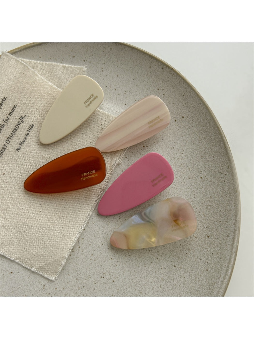 Beau pink tone hair clip held in hand showing size and shape