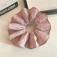 Close-up of soft pink scrunchie fabric texture and stitching details